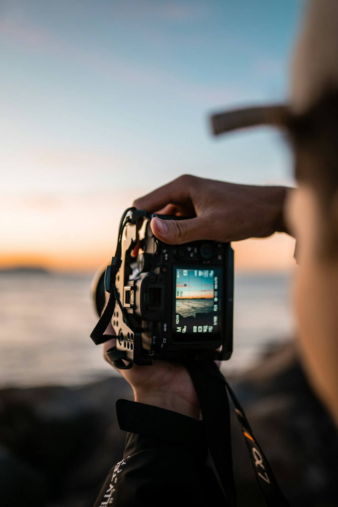 Close-up of man taking pictures with his Sony camera at the beach. Follow me on insta @bailey.shoots